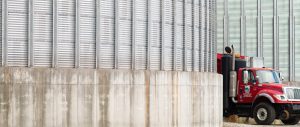 image of a red truck in between grain elevators