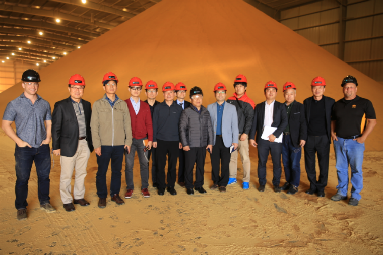 People Standing For Photo In Front Of Grain