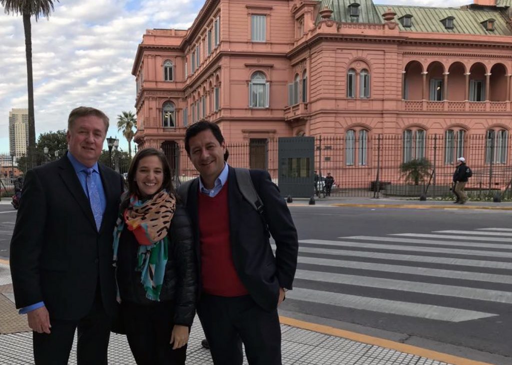 an image of three people smiling for a photo in Argentina