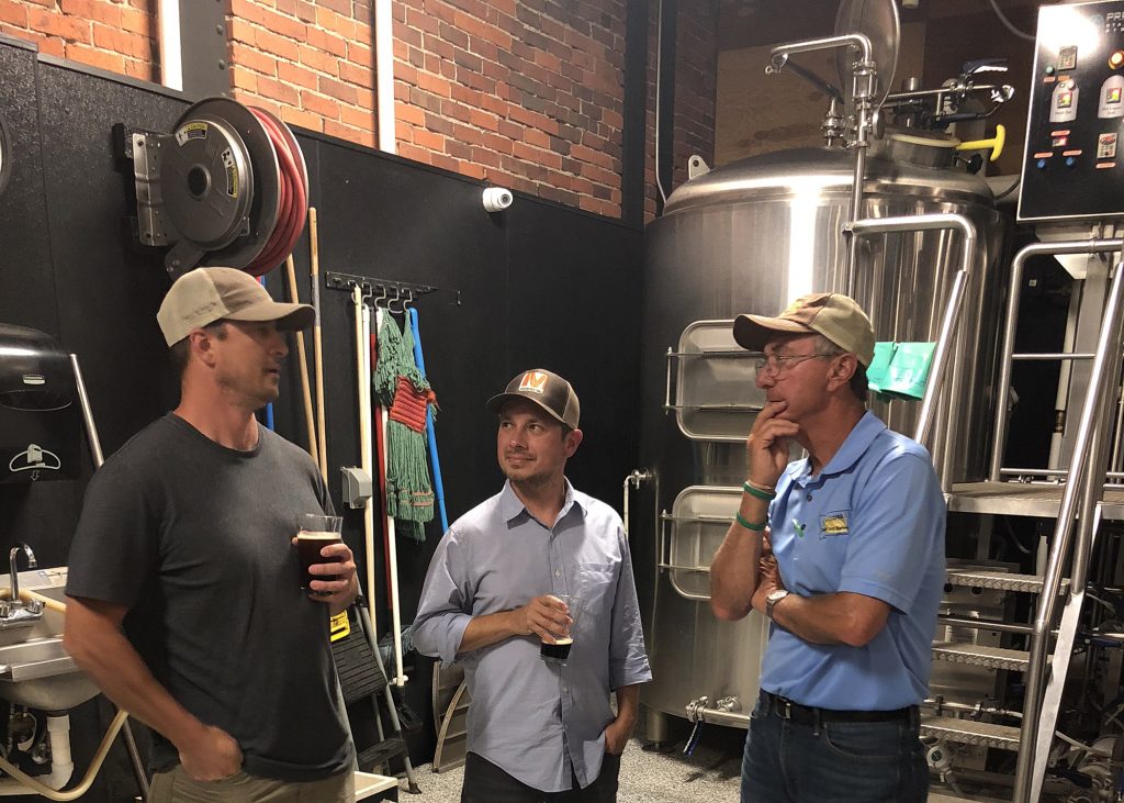 an image of Brewers speaking in front of a still