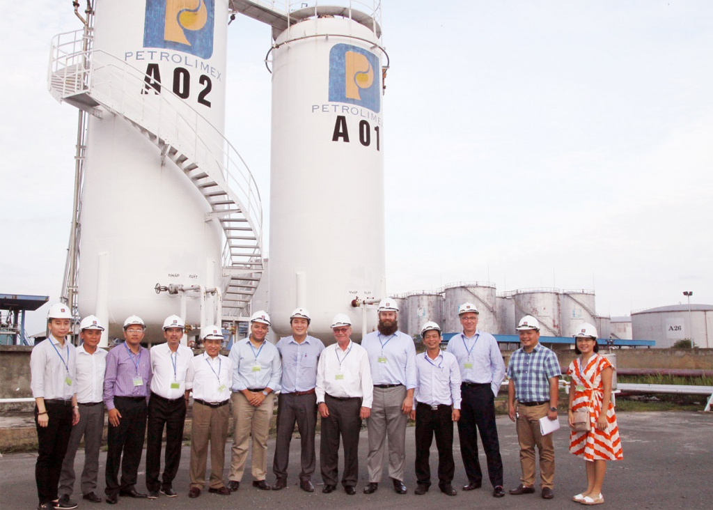 image of a Vietnam Ethanol team in front of large silos