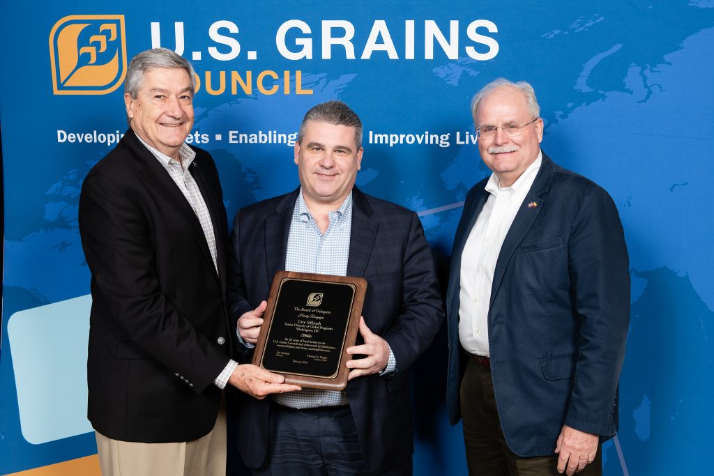 3 Men Holding Plaque