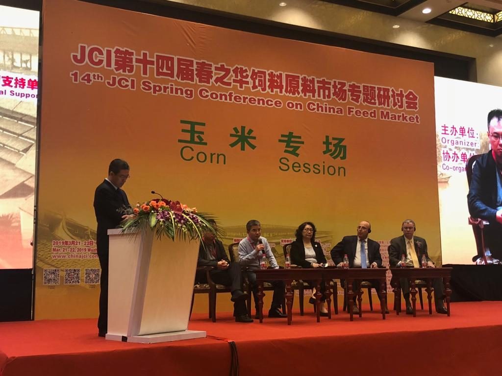 people speaking on a panel at corn meeting in China