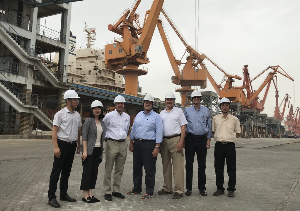 image of seven people wearing hard hats standing in front of machinery in China