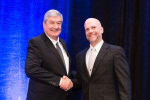 USGC Past Chairman Jim Stitzlein and USGC Chairman Darren Armstrong shaking hands