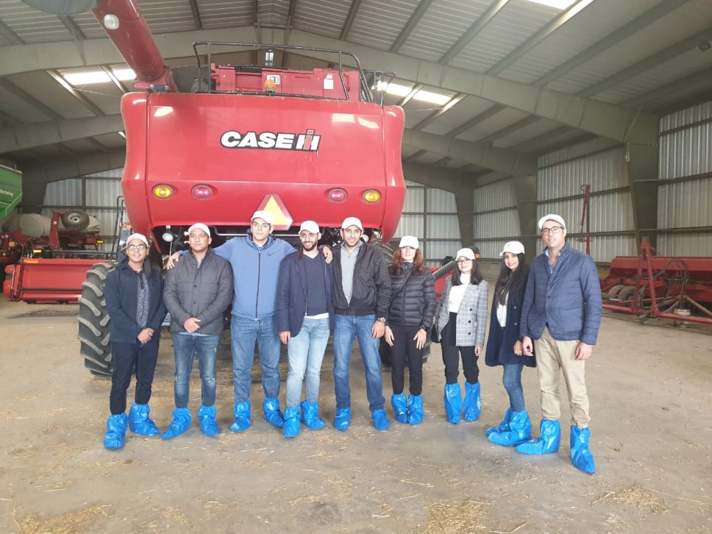 MEA Team- group photo of team members standing in front of farm equipment