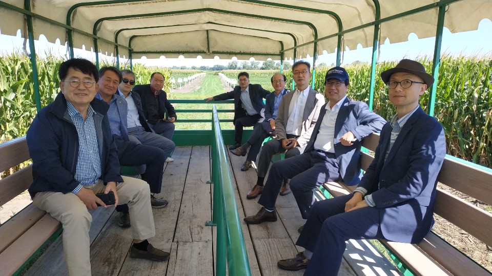 South Korea Team in a wagon in the corn research field