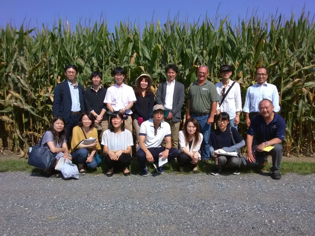 2018 Japanese Biotech Team- Group photo of team in front of a corn field