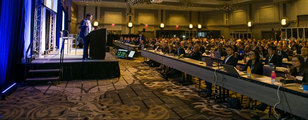 Global Ethanol Summit speaker, speking at a podium on stage in front of an audience