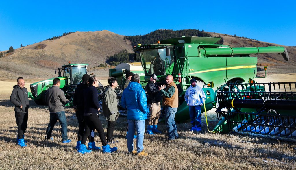 Chinese Malt Barley Team to Idaho 2019- team members standing in front of farm equipment learning about the equipment
