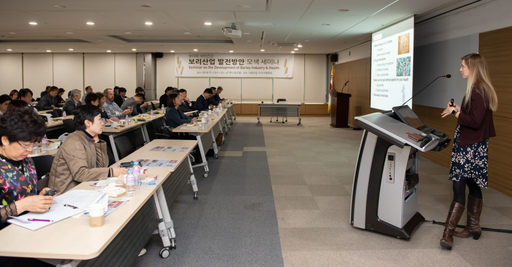 2019 Korea Food Barley Seminar- woman speaking at podium to attendees