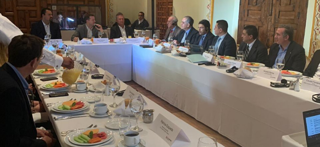 USDA Meeting in Mexico, gentlemen sitting at table engaged in a discussion