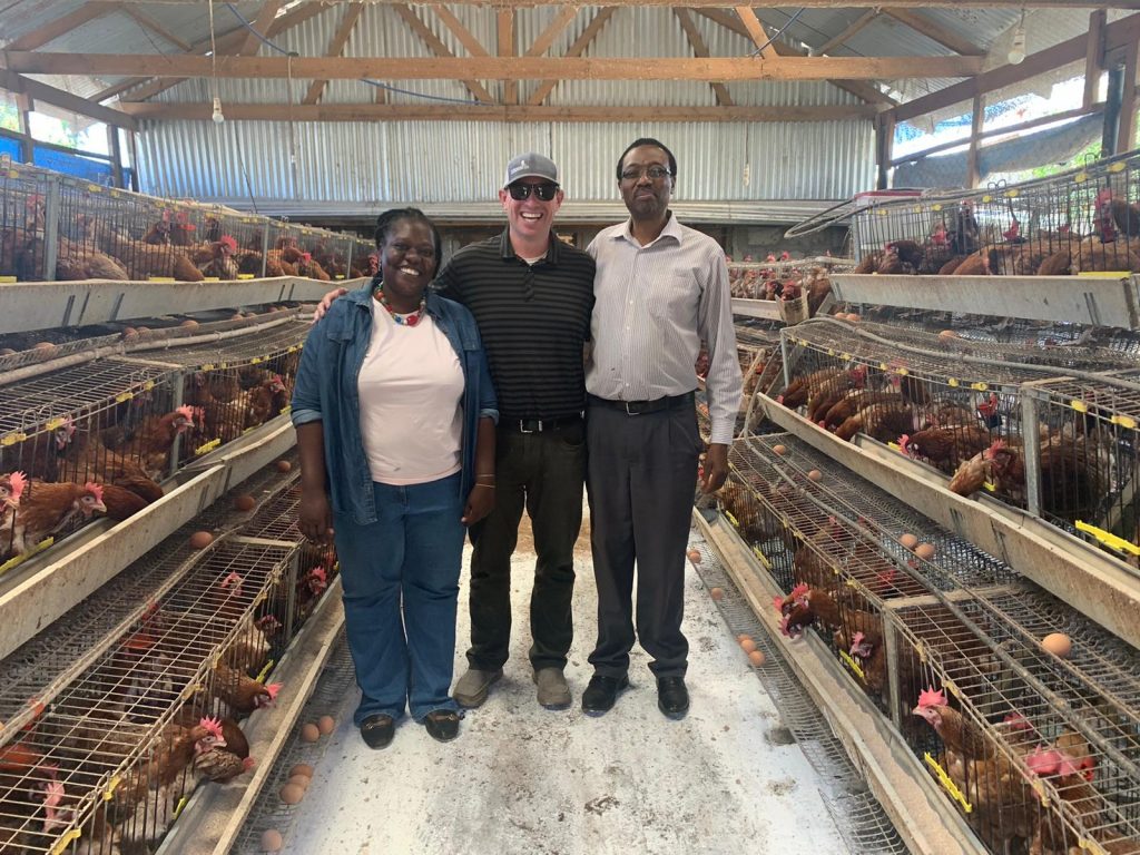 three people in a poultry facility in Tanzania