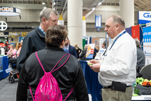 image of a man speaking to two people