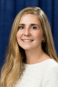 Image of a woman with blonde hair wearing a white shirt