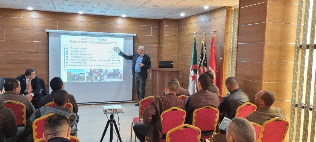 a man presenting to a group of attendees