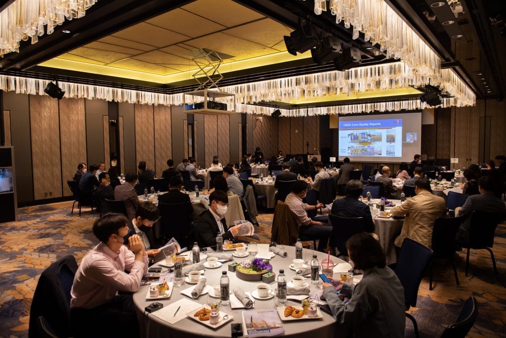 image of many people at tables listening to a presentation