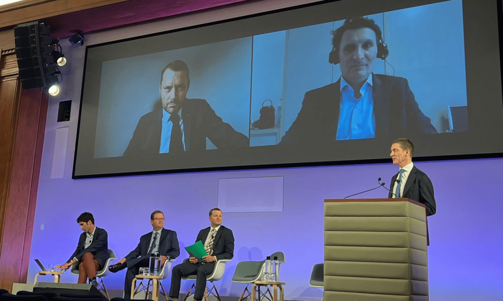 picture of men taking part in a panel at a conference