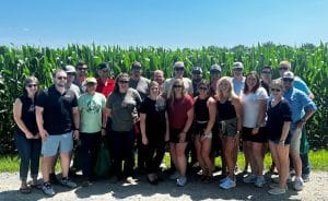 image of group of people in front of corn field