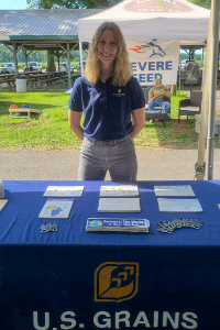 Image of girl standing at a trade show booth table