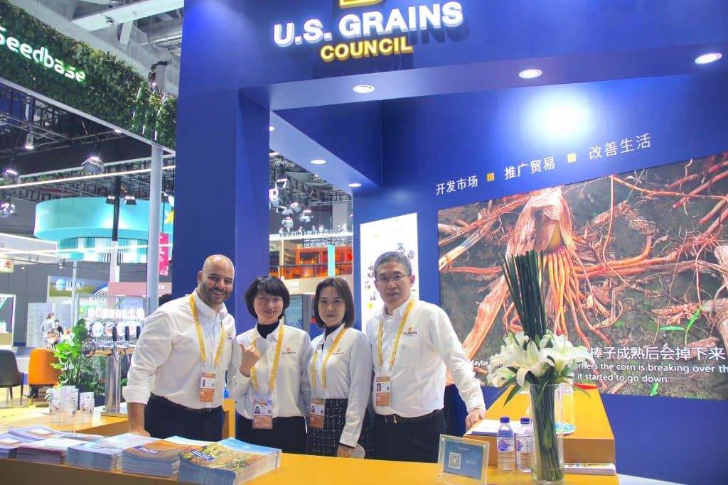 image of four people in a trade show booth in China