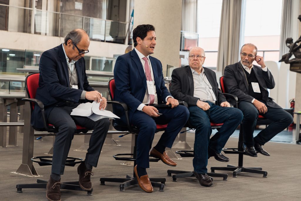 image of four men speaking on a panel