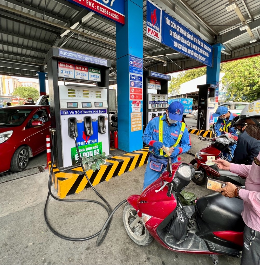 image of man pumping gas at a gas station in Vietnam
