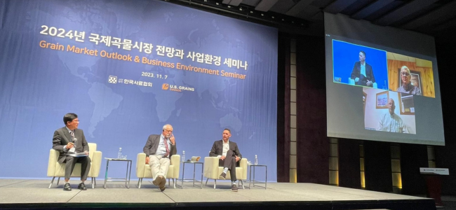 image of three men on a panel on stage