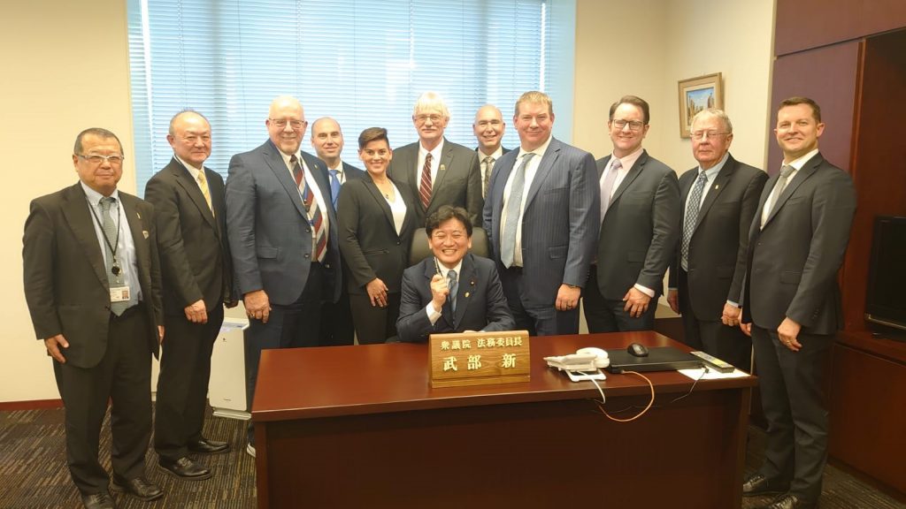 image of group of people in suits with a Japanese government official