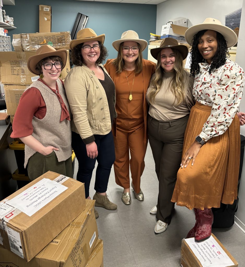 A group of women posing in a storage room