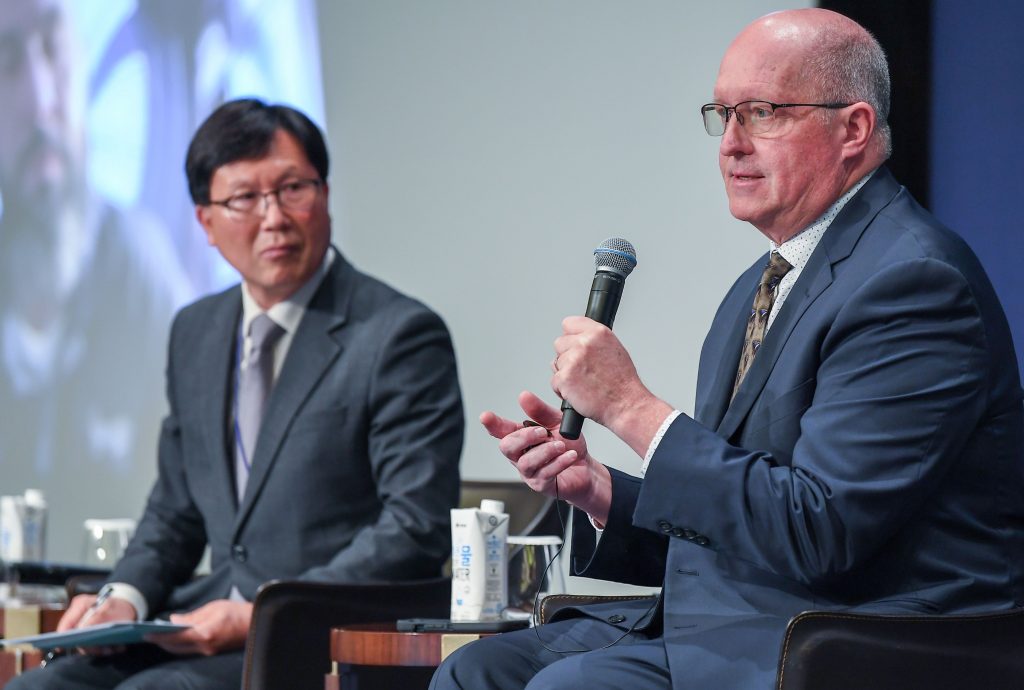 Two men on a conference stage