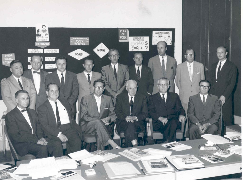 A black and white photo of men in suits and ties