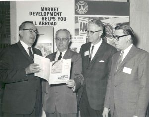 Four men reading a brochure