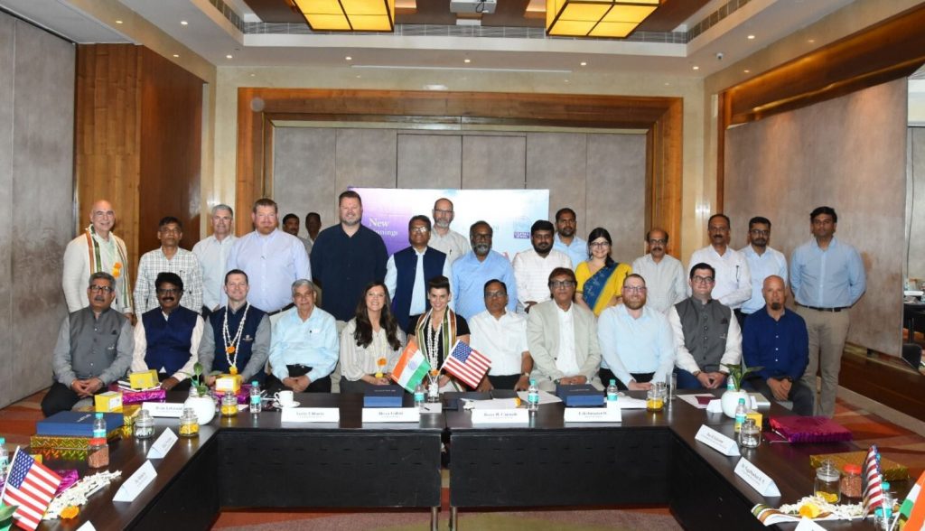 A group of people in a conference room posing for a photo