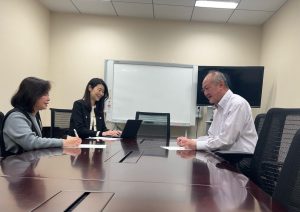 Two women and a man sitting at a table